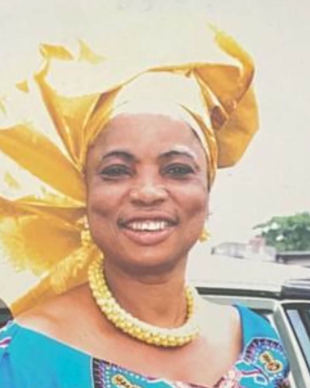 Prophetess Hannah Okoh, smiling, in a gold gele and a gold necklace.